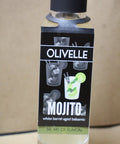 Bottle of Olivelle Mojito with a black label on a beige background
