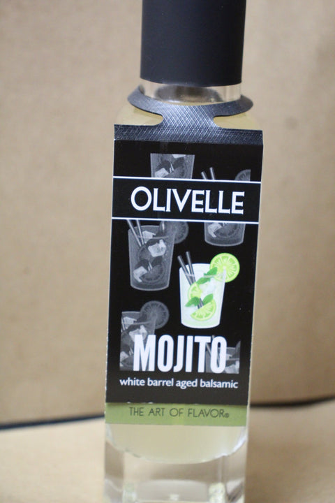 Bottle of Olivelle Mojito with a black label on a beige background