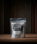 Dry shampoo package on a wooden surface with a dark background