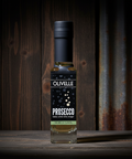 Bottle of Olivelle Prosecco on a wooden surface with a rustic background