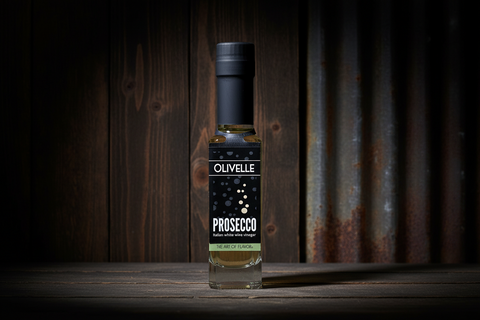 Bottle of Olivelle Prosecco on a wooden surface with a rustic background