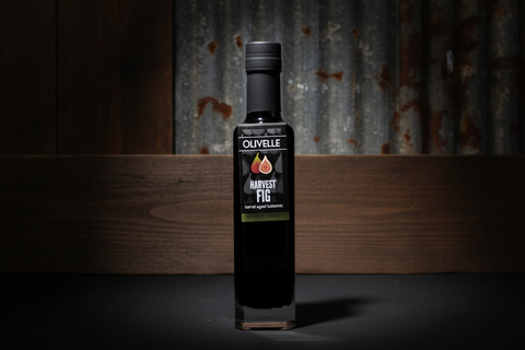 Bottle of Olivelle Harvest Fig olive oil on a dark background