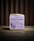 Bar of soap with a 'Lovely Lavender' label on a wooden surface