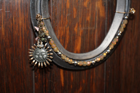 Live Lucky Decorative Horseshoe with Bronze Sun Face Charm and Earthtone Beads