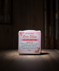 Bar of soap with a label on a wooden surface
