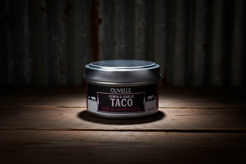 Jar of Olivelle Taco on a wooden surface with a dark background