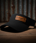 Black cap with a 'Michigan' patch on a wooden surface with a rustic background