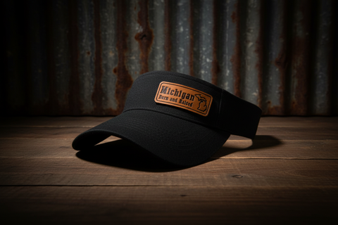 Black cap with a 'Michigan' patch on a wooden surface with a rustic background