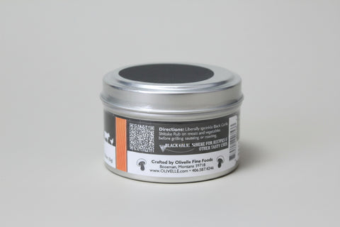 Silver container with black lid on a gray background