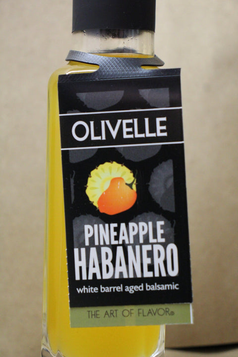 Bottle of Olivelle Pineapple Habanero white barrel aged balsamic on a beige background