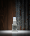 Small white bottle labeled 'Dry Shampoo' on a dark background