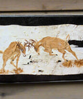 Wooden plaque with deer design on a wooden surface