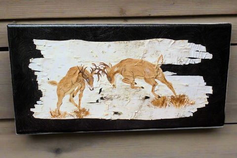 Wooden plaque with deer design on a wooden surface