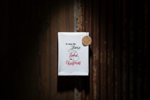 White towel with text hanging on a wooden wall
