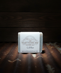 Bar of soap with a label on a wooden surface
