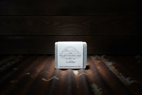 Bar of soap with a label on a wooden surface