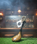 Golf club with a flag on a grassy surface in front of a bar with bottles and glasses.