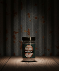 Jar of pasta rocks with a label on a wooden surface and dark curtain background