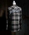 Plaid shirt with 'Made in Michigan' text on a mannequin against a dark background