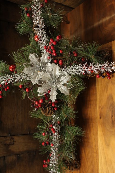 Festive Holiday Cross with Silver Poinsettias, Red Berry Accents, and Evergreen