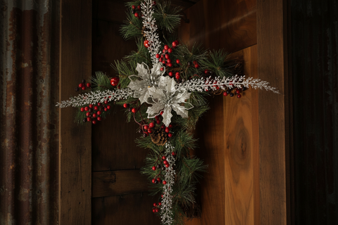 Festive Holiday Cross with Silver Poinsettias, Red Berry Accents, and Evergreen