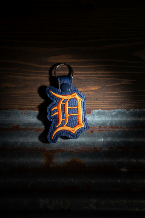 Keychain with a logo on a dark, textured background