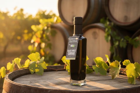 Bottle of Olivelle Black Garlic Tamari on a beige background