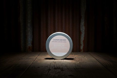 Round product container with 'Almuth Bee Farm' label on a wooden surface